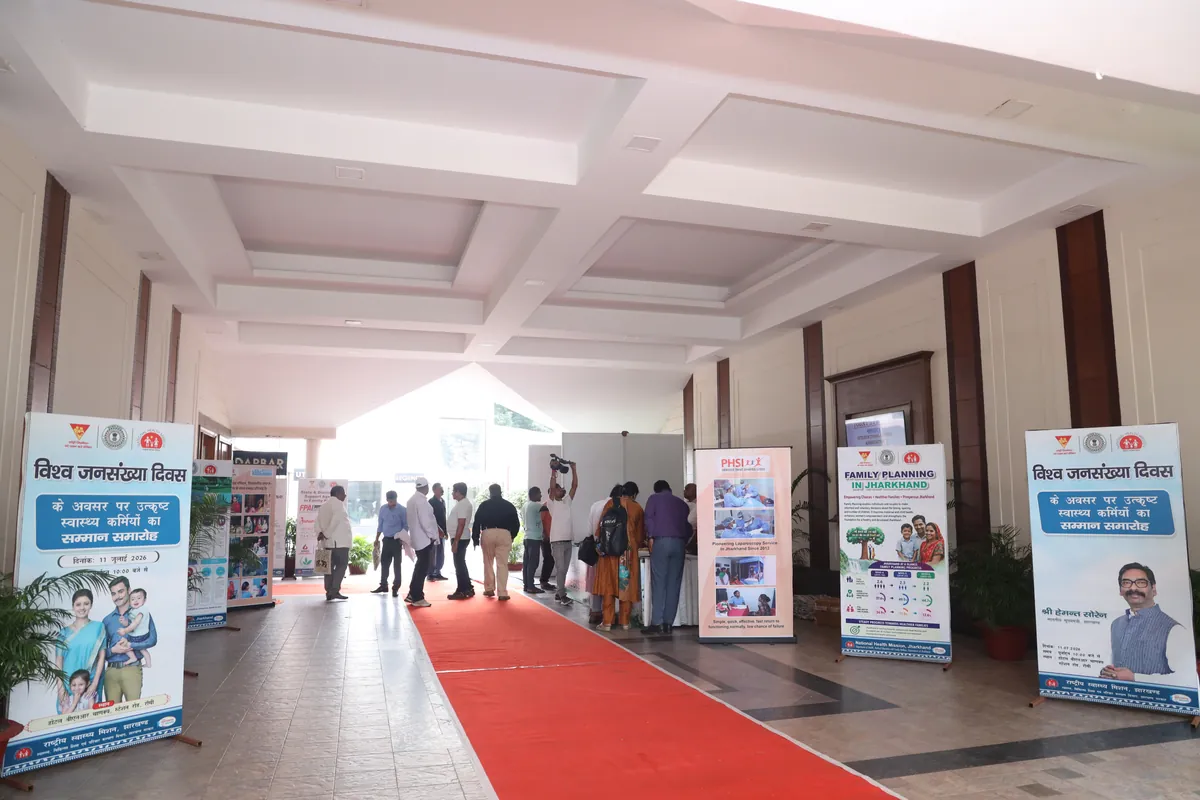 Government health event Ranchi - World Population Day exhibition stalls and red carpet venue setup